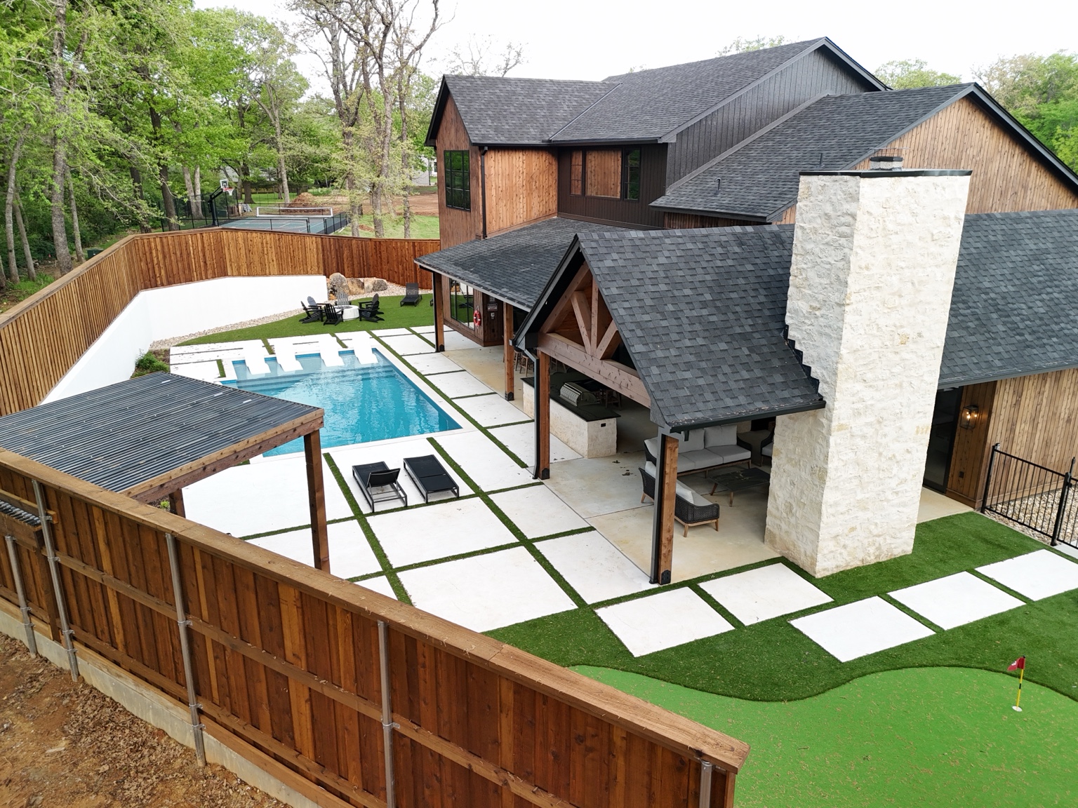 Aerial view of luxury home, pool and outdoor living area