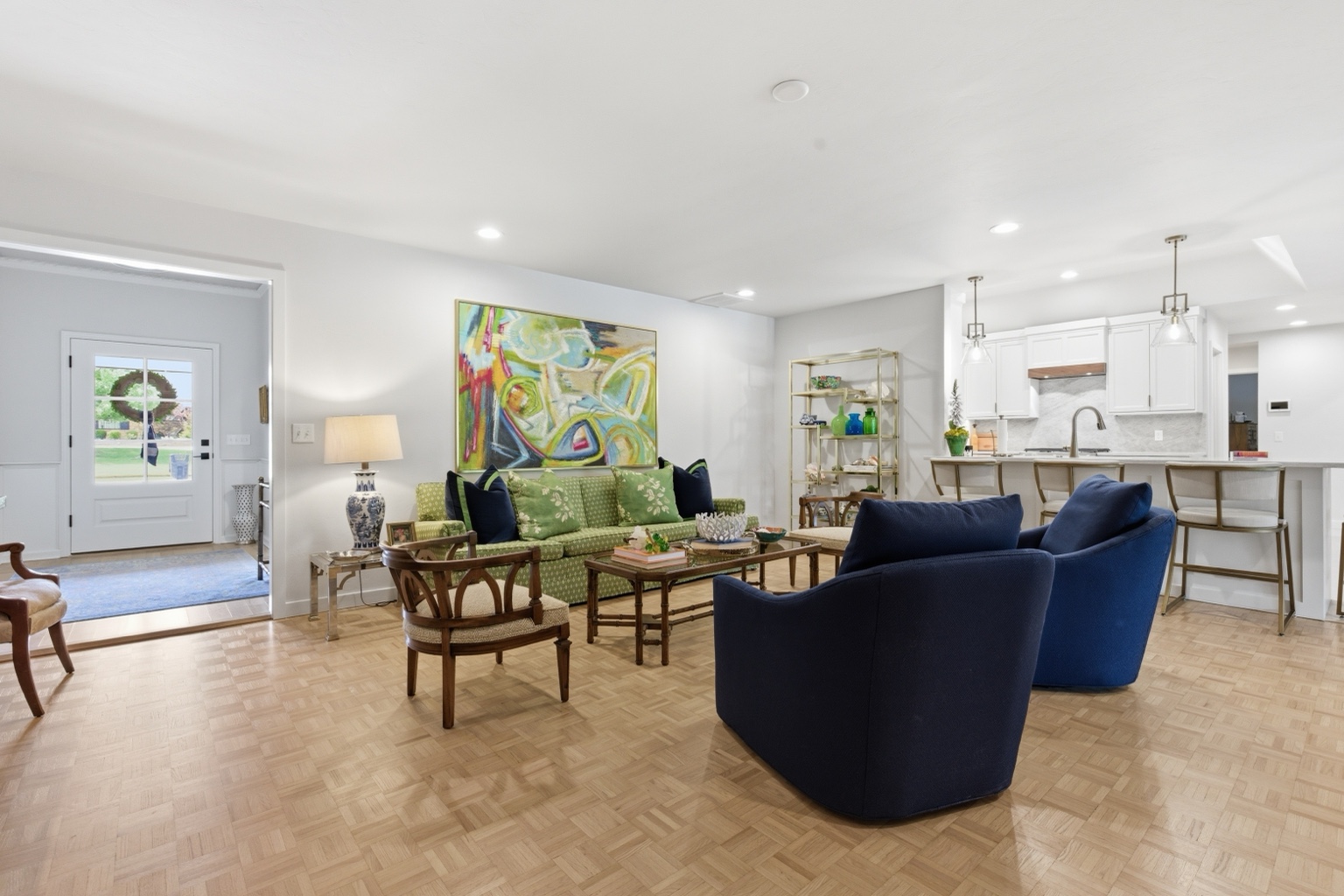 Formal living room with colorful artwork and open kitchen