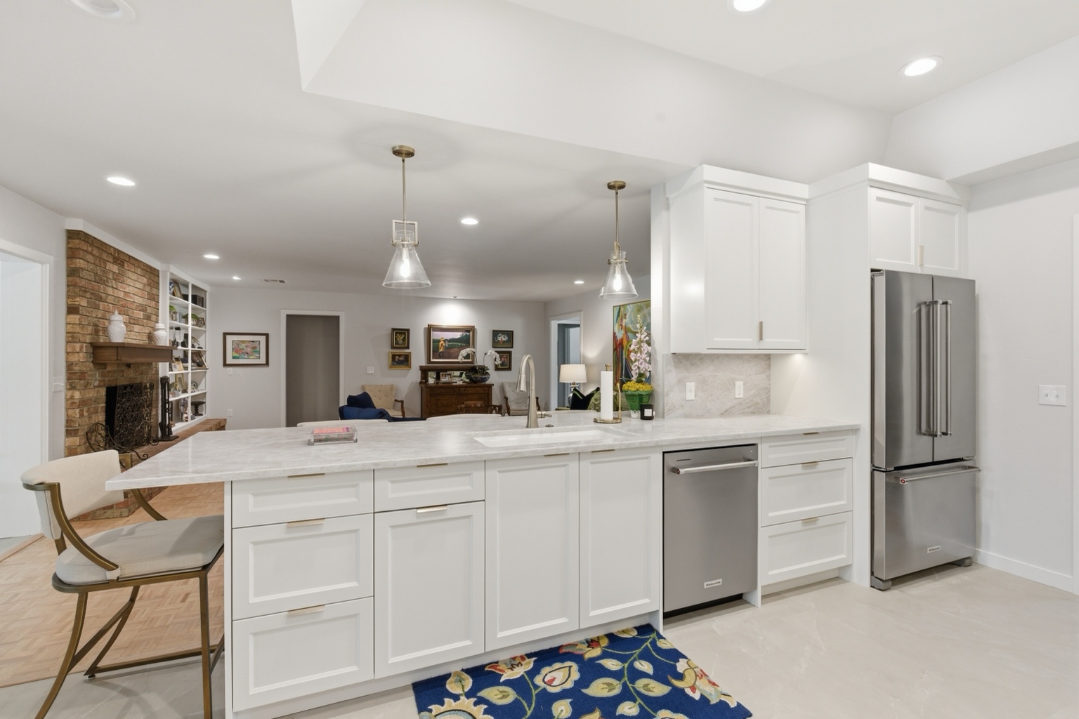 Bright white kitchen with large island and stainless steel appliances